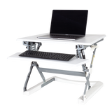 PLUS 35" sit stand workstation fully extended with a laptop on the surface. 